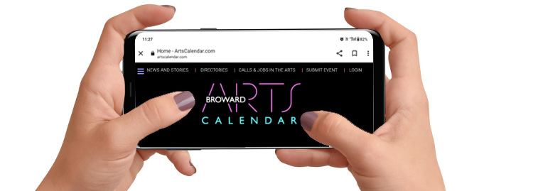 hands holding a phone with artscalendar website.